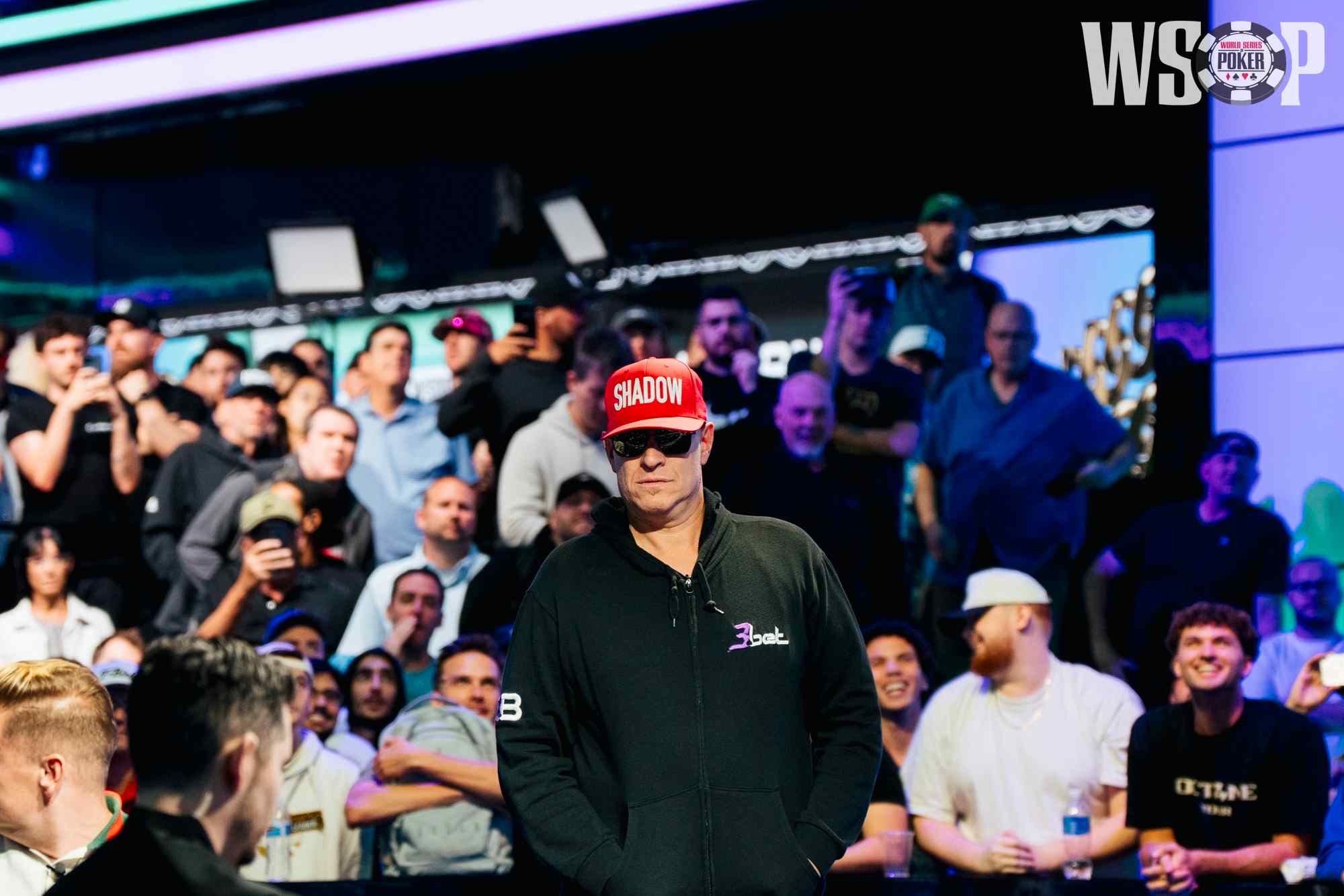 Greg Mueller sweats a hand at the 2026 WSOP Main Event with fans in the background.